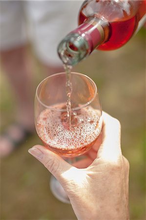 simsearch:614-06043612,k - Woman pouring glass of wine outdoors Stock Photo - Premium Royalty-Free, Code: 614-08870515