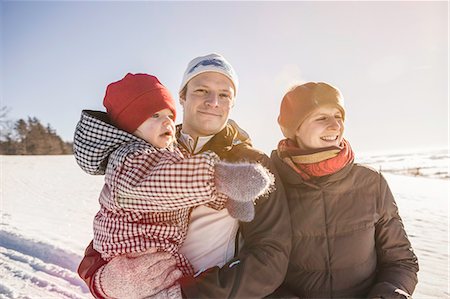 simsearch:614-06896861,k - Smiling family walking in snow Stock Photo - Premium Royalty-Free, Code: 614-08870574