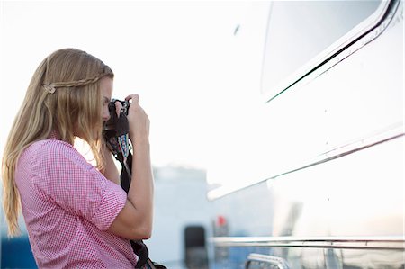 Woman taking picture of reflection Stock Photo - Premium Royalty-Free, Code: 614-08870734
