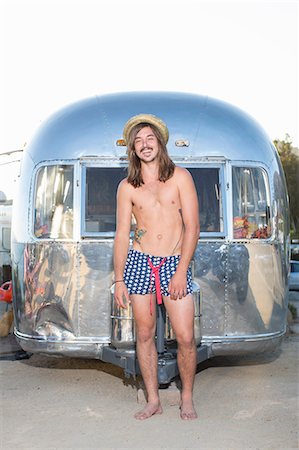 Man wearing swimsuit by trailer Stock Photo - Premium Royalty-Free, Code: 614-08870731