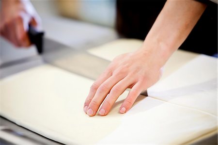 simsearch:649-06165027,k - Baker slicing dough in kitchen Stock Photo - Premium Royalty-Free, Code: 614-08871088