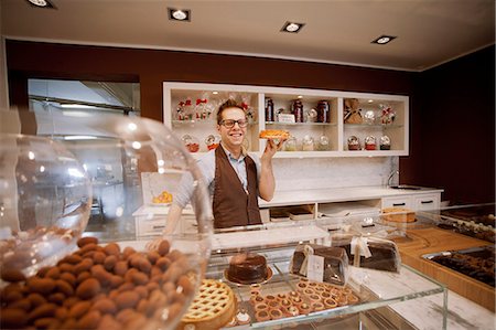 supermarket baker - Cashier holding fruit cake in bakery Stock Photo - Premium Royalty-Free, Code: 614-08871102