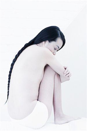sit hugging knee - Nude woman with braided hair Stock Photo - Premium Royalty-Free, Code: 614-08871341