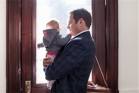 simsearch:614-06623416,k - Businessman holding baby daughter Stock Photo - Premium Royalty-Free, Code: 614-08871469