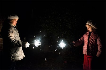 spark - Girls playing with sparklers at night Stock Photo - Premium Royalty-Free, Code: 614-08871476