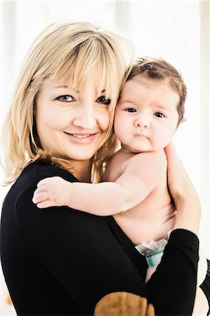 Portrait of mid adult mother holding baby boy Stock Photo - Premium Royalty-Free, Code: 614-08871602