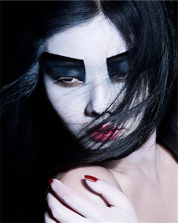 Young woman with dramatic makeup, black eyeshadow Photographie de stock - Premium Libres de Droits, Code: 614-08871737