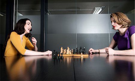 simsearch:649-07239830,k - Two business executives playing chess in meeting room Stock Photo - Premium Royalty-Free, Code: 614-08871814