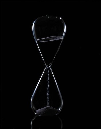 Hour glass on black background Stock Photo - Premium Royalty-Free, Code: 614-08871861