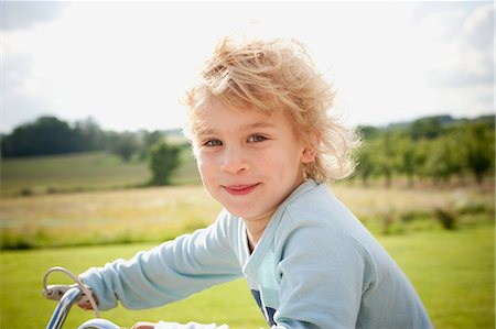 Boy on bicycle in countryside Stock Photo - Premium Royalty-Free, Code: 614-08871928