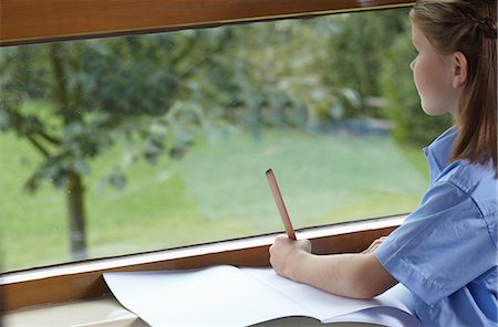 simsearch:614-06896117,k - School girl holding a pencil and staring out of a classroom window Stock Photo - Premium Royalty-Free, Code: 614-08872867