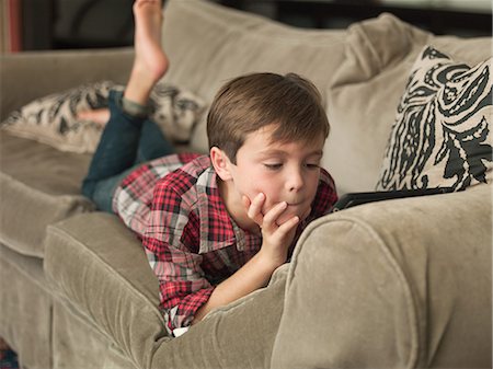 simsearch:649-09078617,k - Boy playing with digital tablet on sofa Stock Photo - Premium Royalty-Free, Code: 614-08873038
