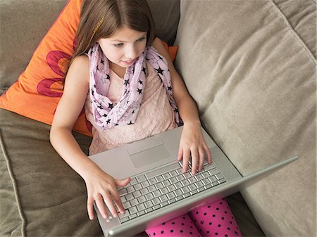 simsearch:614-06442812,k - Girl using laptop on sofa, elevated view Stock Photo - Premium Royalty-Free, Code: 614-08873051