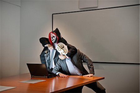 strangle - Businessmen in masks fighting over laptop Stock Photo - Premium Royalty-Free, Code: 614-08873080