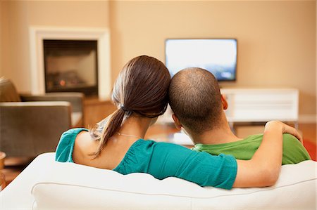 people home comfort adult - Couple watching television, rear view Stock Photo - Premium Royalty-Free, Code: 614-08873462