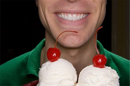 simsearch:614-06537664,k - Smiling man holding ice cream and cherries Stock Photo - Premium Royalty-Free, Code: 614-08873639