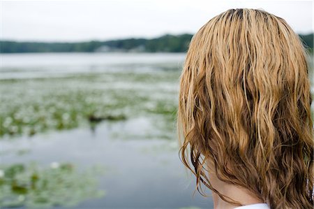 Woman at edge of lake with wet hair Stock Photo - Premium Royalty-Free, Code: 614-08873748