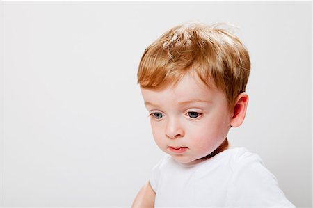 shy baby - Baby boy looking down Stock Photo - Premium Royalty-Free, Code: 614-08873874