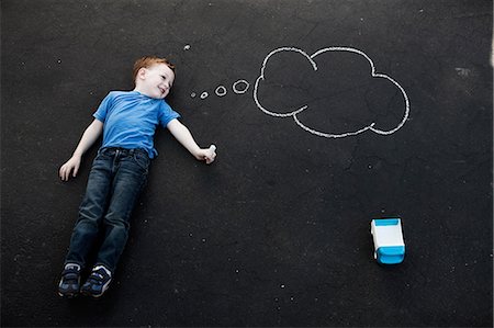 simsearch:614-06043612,k - Boy lying on floor with chalk thought bubble Stock Photo - Premium Royalty-Free, Code: 614-08873955