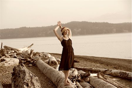 simsearch:614-08065889,k - Woman standing on driftwood and stretching Stock Photo - Premium Royalty-Free, Code: 614-08873983