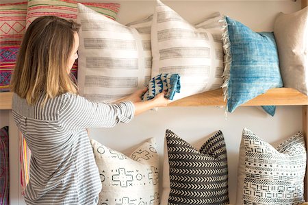 simsearch:6118-08202525,k - Rear view of female interior designer trying textile against cushions in retail studio Stock Photo - Premium Royalty-Free, Code: 614-08884372