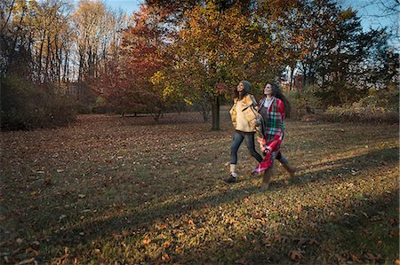 pennsylvania woods - Two female friends striding across autumn park Stock Photo - Premium Royalty-Free, Code: 614-08884471