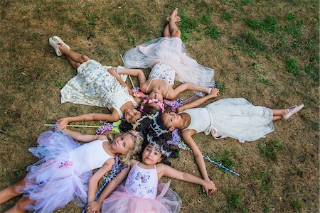 simsearch:614-03469543,k - Group of young girls dressed as fairies, lying in circle, heads together Stock Photo - Premium Royalty-Free, Code: 614-08884909