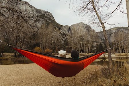 simsearch:614-05557077,k - Rear view of couple reclining in red hammock looking out at landscape, Yosemite National Park, California, USA Stock Photo - Premium Royalty-Free, Code: 614-08880798