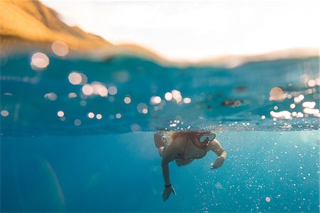 Woman swimming underwater, Oahu, Hawaii, USA Stock Photo - Premium Royalty-Free, Code: 614-08880824