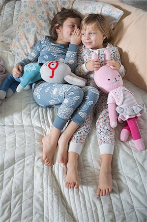 secret - Sisters sharing secret on bed Stock Photo - Premium Royalty-Free, Code: 614-08881251