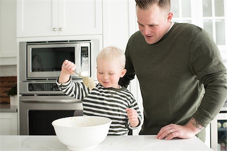 Father and son baking together, son mixing mixture Stock Photo - Premium Royalty-Free, Code: 614-08881347