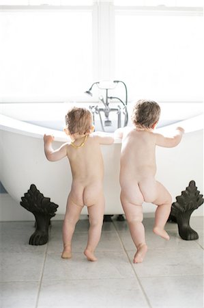 female kid bath - Rear view of male and female toddlers looking into bathtub Stock Photo - Premium Royalty-Free, Code: 614-08908401