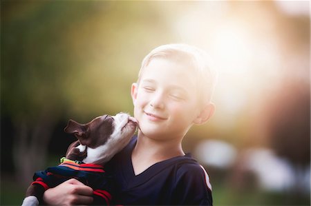 dog lick - Boston Terrier puppy licking boy's face Stock Photo - Premium Royalty-Free, Code: 614-08908650