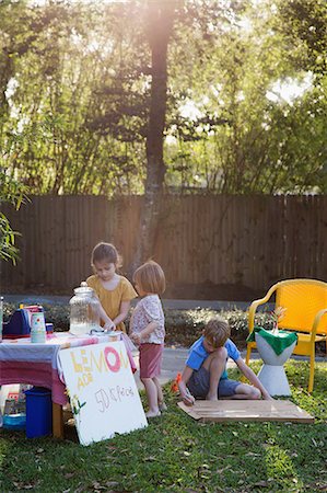 simsearch:614-07806393,k - Boy and two young sisters preparing lemonade stand in garden Stock Photo - Premium Royalty-Free, Code: 614-08946613