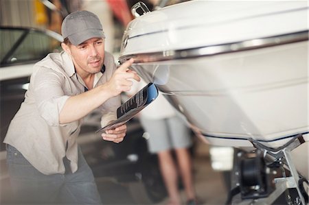 simsearch:649-07710266,k - Man checking bodywork on boat in repair workshop Stock Photo - Premium Royalty-Free, Code: 614-08946625