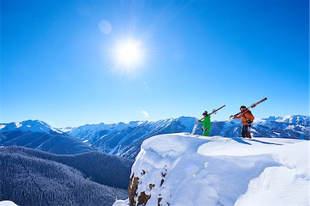 snowy mountains of aspen - Two male skiers looking out from snow covered ridge, Aspen, Colorado, USA Stock Photo - Premium Royalty-Free, Code: 614-08983384