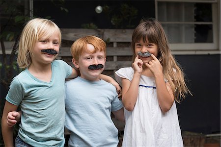 simsearch:614-03469543,k - Children wearing fake mustaches looking at camera smiling Stock Photo - Premium Royalty-Free, Code: 614-08991141