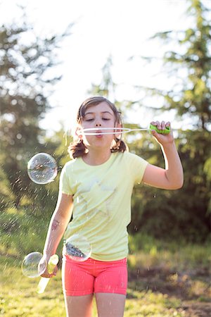 simsearch:632-05604245,k - Young girl blowing bubbles outdoors Stock Photo - Premium Royalty-Free, Code: 614-09017291