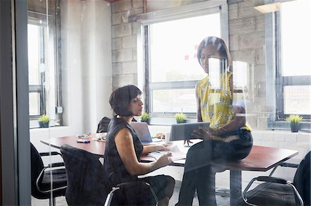 simsearch:614-06718107,k - Two women working together in meeting room, brainstorming, using digital tablet Stock Photo - Premium Royalty-Free, Code: 614-09017714