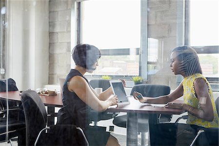 simsearch:614-06718107,k - Two women working together in meeting room, brainstorming, using digital tablet Stock Photo - Premium Royalty-Free, Code: 614-09017716