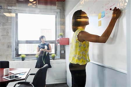 simsearch:614-06718107,k - Two women in office, solving problem, using whiteboard, sticky notes stuck on whiteboard Stock Photo - Premium Royalty-Free, Code: 614-09017726