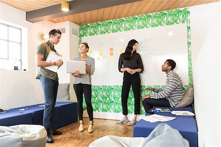 Young businessmen and women having discussions in creative meeting room Stock Photo - Premium Royalty-Free, Code: 614-09026871