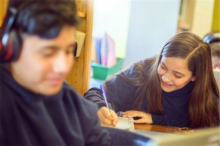 simsearch:640-02765460,k - Teenage boy and girl doing schoolwork at classroom desks Stock Photo - Premium Royalty-Free, Code: 614-09056538