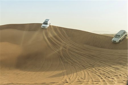dune driving - Off road vehicles driving down desert dunes, Dubai, United Arab Emirates Stock Photo - Premium Royalty-Free, Code: 614-09056569