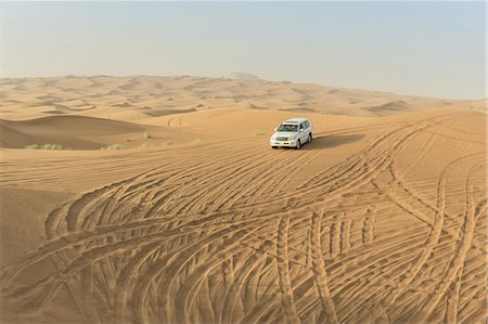 dune driving - Off road vehicle driving down desert dunes, Dubai, United Arab Emirates Stock Photo - Premium Royalty-Free, Code: 614-09056570