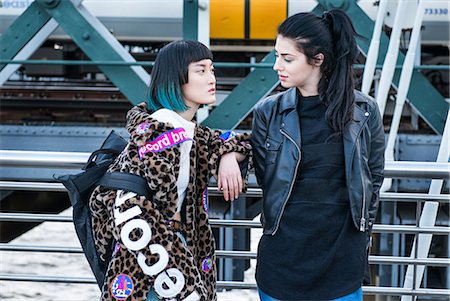 simsearch:649-08922723,k - Two young stylish women leaning against handrail on millennium footbridge, London, UK Stock Photo - Premium Royalty-Free, Code: 614-09057115