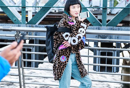 simsearch:649-08922723,k - Stylish young woman making smartphone call while strolling on millennium footbridge, London, UK Stock Photo - Premium Royalty-Free, Code: 614-09057116