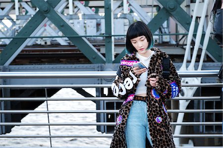 simsearch:649-08922723,k - Stylish young woman looking at smartphone on millennium footbridge, London, UK Stock Photo - Premium Royalty-Free, Code: 614-09057117