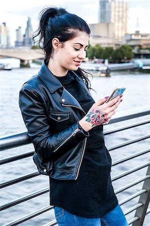 simsearch:649-08922723,k - Young woman looking at smartphone on millennium footbridge, London, UK Stock Photo - Premium Royalty-Free, Code: 614-09057118