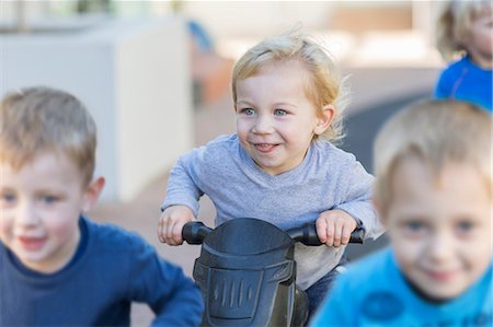 simsearch:614-07806393,k - Boys at preschool racing push motorbikes in garden Stock Photo - Premium Royalty-Free, Code: 614-09057239